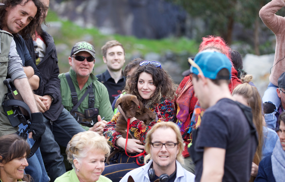 Lauren Brunswick, Producer, with Tucka as Puppy Koko, surrounded by cast and crew.