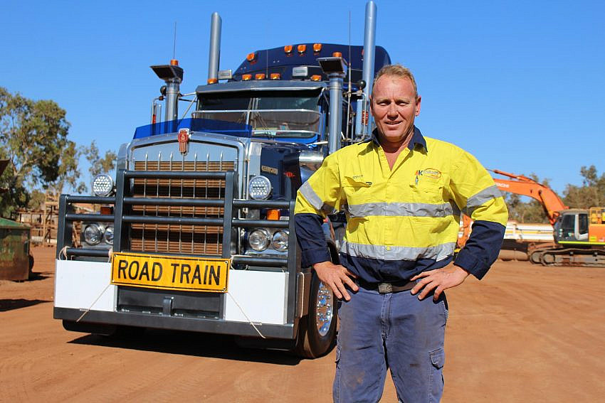 Person in high-vis clothing standing in front of a truck