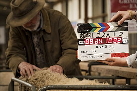 Film clapper with Sam Neil and a sheep in the background