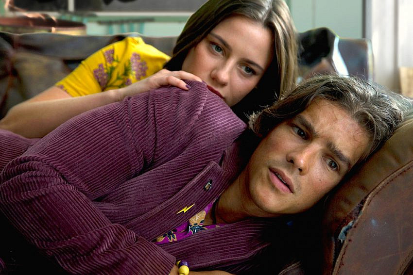 Brenton Thwaites as ‘Devon’ and Lily Sullivan as ‘Lucy’ on a couch in I Met A Girl
