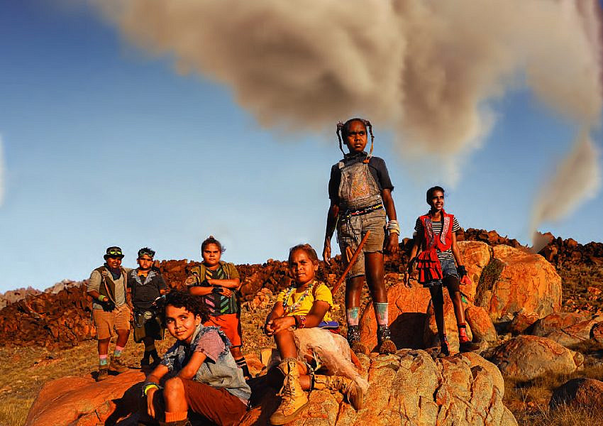 Cast of Thalu in the outback with smoke in the background