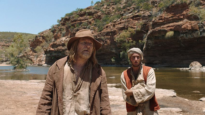 David Wenham and Ahmed Malek by a river with a rocky gorge in the background